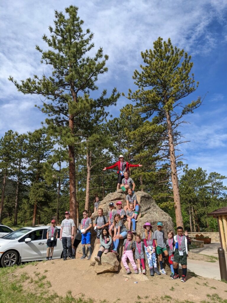 The campers pose together on a giant rock before heading out on their group hike.