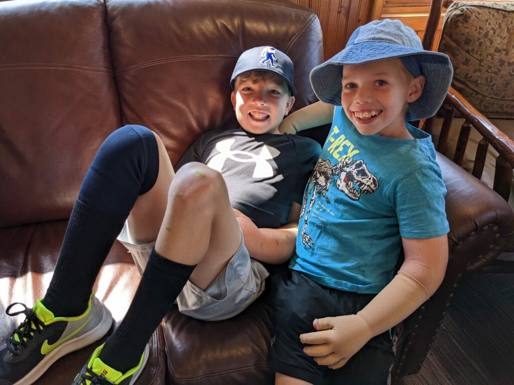 Bryce and Kyle sit together on the couch.