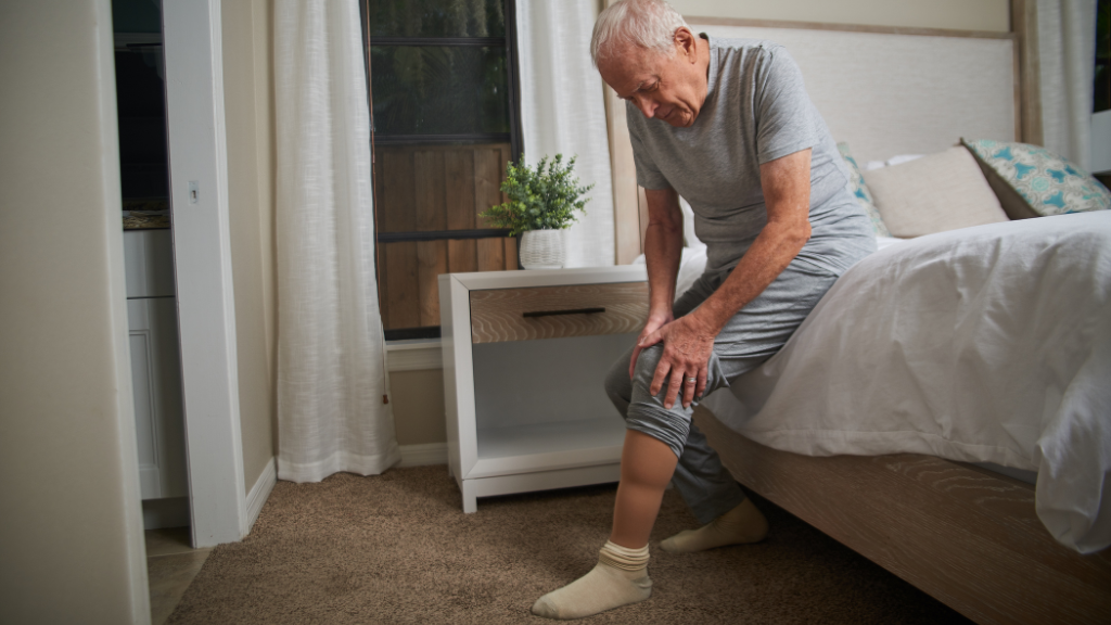 Senior man grabbing his knee in pain