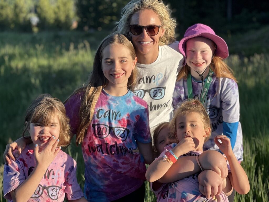 Brittany Williams poses with a group of young campers with lymphedema at Camp Watchme.